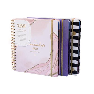 China Custom Hardcover Cardboard Cover Gold Elastic Ribbon Planner Coil Notebook for sale