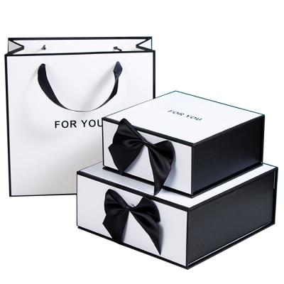 China Recyclable Logo Black Rigid Paper Cardboard Custom Gift Box And Gift Bag Magnetic Packaging Boxes With Ribbon for sale