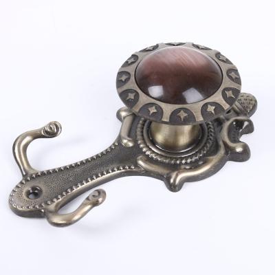 China Traditional Quality assurance fashion design small metal hooks adjustable safe curtain tie back hooks for sale