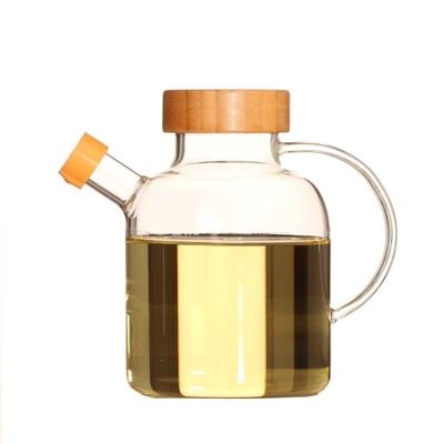 China Sustainable New Design 650ml Kitchen Glass Oil Jar With Bamboo Lid And Glass Handle for sale