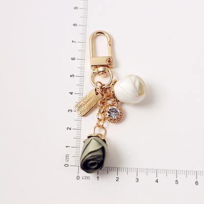 China Promotion Gift Synthetic Fabric Cute Soft Trinket Rose Camellia Flowers Keychain For Women Rose Keychain for sale