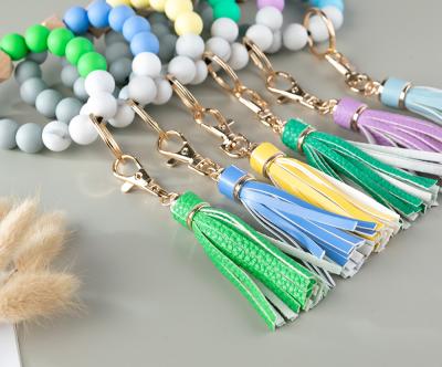 China Promotion Gift Hot Sale Women Multicolor Tassel Beads Bracelet Beaded Wooden Bead Bracelet Wrist Silicone Key Chain for sale