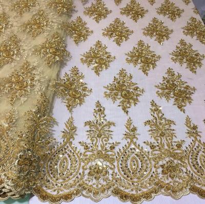 China New top end Shrink-resistant fashion design gold color machine beaded heavy lace fabric embroidery fabric for formal dress or bridal for sale