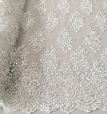 China New design Shrink-resistant white bridal fashion lace machine embroidery fabric beaded sequin lace fabric for dresses for sale