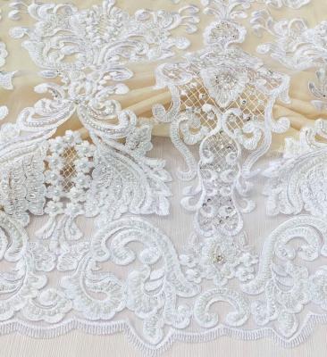 China Luxury Shrink-Resistant All Over White Wedding Lace Fabric With Heavy Hand Beaded Rhinestones Embroidery Lace Fabric For Bridal for sale