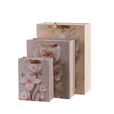 China Recyclable Cheap Flower Modern Customizable Shiny Small Quantity Pointed Boutique Paper Bottom Carrier Bags for sale