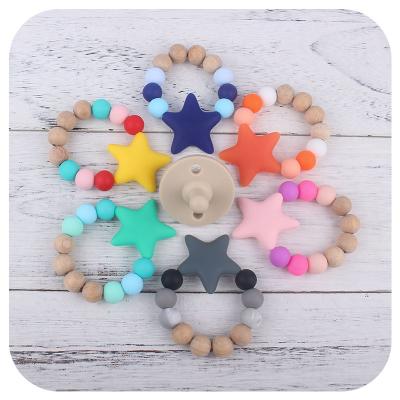 China Soft Toy Newest Infant Silicone Star Wristband for Baby Molar Stick Baby Teether Wooden Rattle and Silicone Baby Accessories Toys for sale