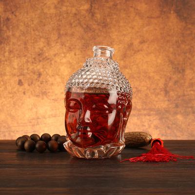 China Unique Buddha Head Shaped Glass Bottles with Aluminum Plastic PP Collar Material for sale