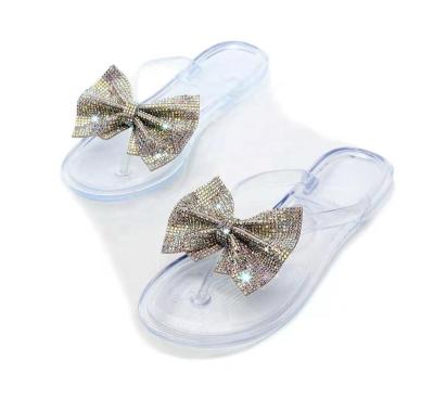 China Smell Proof Outside Butterfly-knot Solid Open Toe Bling Shallow Jelly Bow Transparent Women Flat Sandals With Crystals for sale