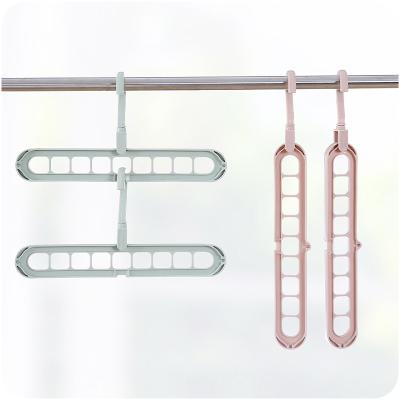 China CLASSIC Wholesale Factory Price Cheap Space Saving Magic Nineholes Plastic Hanger For Clothes for sale