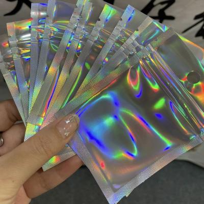 China Recyclable Laser Iridescent Plastic Cosmetic Bags Holographic Zipper Lock Pouches Holographic Makeup Bags Hologram Zipper Bags for sale