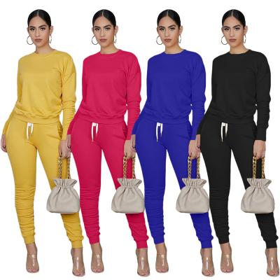 China Solid color long sleeve anti-pilling round neck t-shirt and tight pleated pants women's autumn and winter leisure sports two-piece suit for sale