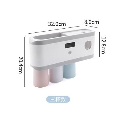 China Sustainable New Design Bathroom Electric Toothpaste Dispenser With Toothbrush Holder for sale