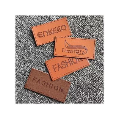 China Handmade Cheap Leather Tag Custom Leather Label Sew On Embossed Leather Labels For Clothes for sale