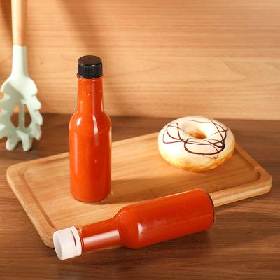 China Empty Glass Sauce Bottle 150ml 5oz Round Glass Bottle For Hot Sauce With Reducer Cap for sale