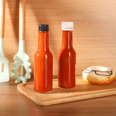 China Juice In Stock Ready To Ship 5oz Glass Sauce Bottle Round Daze Long Neck Glass Bottle For Hot Sauce for sale