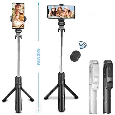 China Foldable easy to carry xt02 cell phone tripod with shutter connected wireless 360 degree rotating selfie stick for outdoor travel for sale