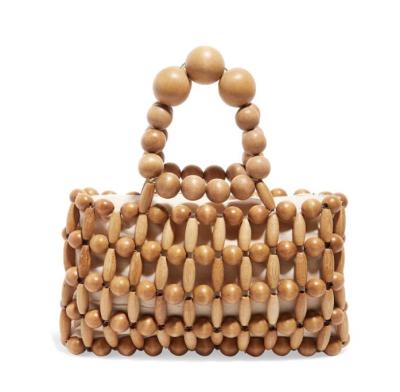 China NEW Wooden Handcrafted Beach Bag Holiday Fashion Women's Beaded Straw Bag Hollow Out Women's Solid Bags for sale