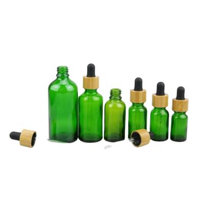 China Super Quality Essential Oil Green Color Essential Oil Glass Bottle With 18/415 Dropper Bamboo Cap for sale