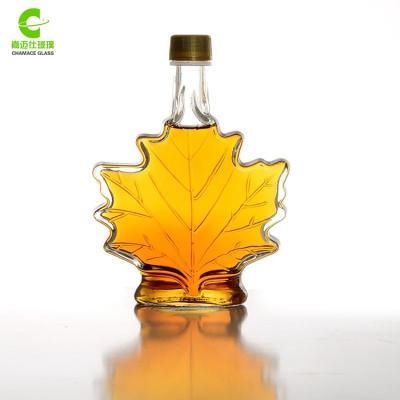 China Fancy Beverage 50ml 100ml 250ml Maple Leaf Glass Wine Bottles With Cap for sale