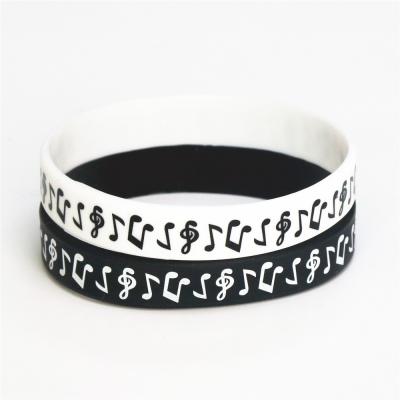 China Customized Design Ink Filled Logo Music Note Silicone Wristband For Music Fans Black Silicone Rubber Wristbands for sale