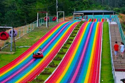 China Outdoor Games Kids Entertainment Plastic Fun Playground Grass Sliding Way Rainbow Snow Dry Slide for sale