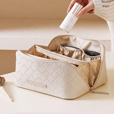 China Fashion New Design Woven Pillow Makeup Bag For Women Travel Large Capacity Wash Bag Portable Separation Storage Bag for sale