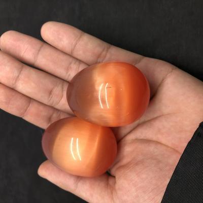 China Hot Sale Wholesale Yoni Crystal Eggs Orange Cat Eye Crystal Eggs from China en venta