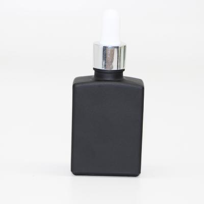 China Recyclable Square 30ml 30ml Perfume Bottle Black Rectangle Glass Dropper Bottles For Essential Oils for sale