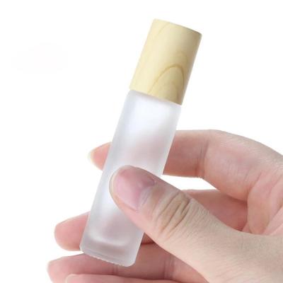 China 10ml Recyclable Frosted Glass Roll On Perfume Bottle For Essential Oil With Plastic Wood Grain Cap In Stock for sale