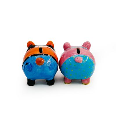 China 2023 Cion bank factory sales ceramic piggy bank small couples jeans pig hot piggy bank home decoration for sale