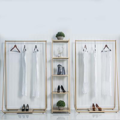 China Customized Fashionable Single Sided Free Standing Storage Rack For Dresses Shoes Bags Elegant Gold Design for sale