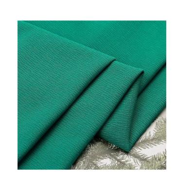 China High quality Tear-resistant pleat jacquard polyester spandex knitted fabric solid color for ladies' garment for sale