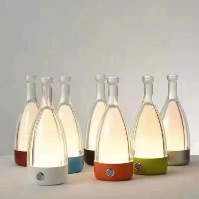 China Multifunction Modern Hotel Bedside Table Lamp Three Color Custom Drunk Bottle Shape for sale