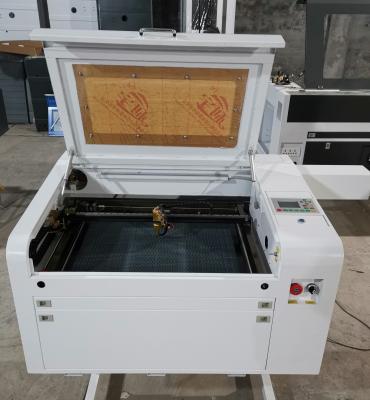 China LIAOCHENG LCSPEAR 4060 RECI 100w CO2 laser water cooled engraving and cutting machine with 400*600mm working table for sale