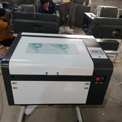 China Water cooled ruida 6445 4060 EFR 80w CO2 laser engraving and cutting machine have good price for sale