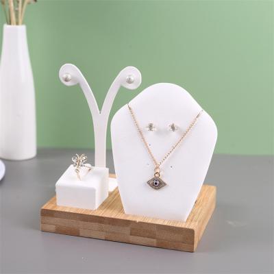 China Jewelry Disply Square Jewelry Stand Solid Wood Jewelry Display Rack PU Bamboo Leather Jewelry Display Set for sale