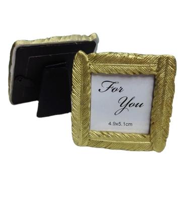 China Resin Ywbeyond Gold Feather Photo Frame For Wedding Small Homecoming Gifts for sale