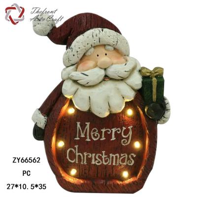 China Christmas figurine Woodlike red santa carring gift craft figurine christmas decoration supplies with led light for sale