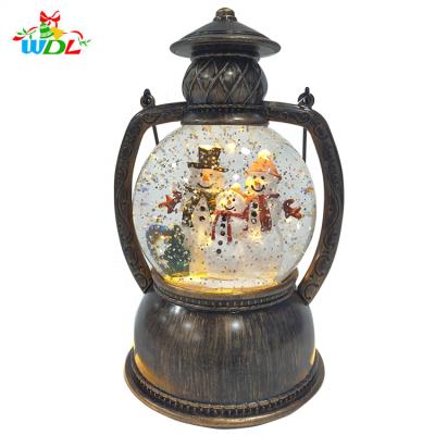 China Christamas Home Decor/Resin Souvenir/Gift Designer Souvenir Water Filled Swirling Lantern Glitter Christmas Table Decor Ornaments Custom Snow Globe With Snow Man for sale