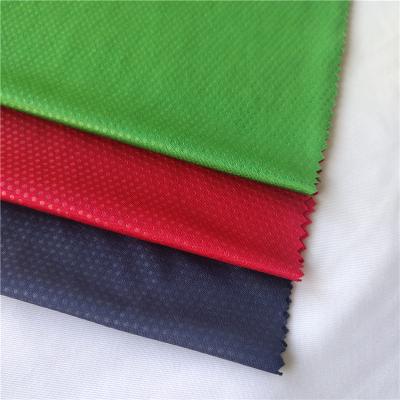 China Memory Shaoxing textile eyelet hole embossed fabrics knit breathable fabric strong coupling for school uniform pants sportswear for sale