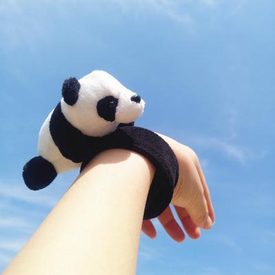 China Cute Lie On Hands Soft Plush Panda Doll Applause Bracelet For Promotional Gift for sale