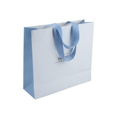 China Recycled Materials Customize Design Silver Paper Bag Fancy Printing Gift Shopping Bag With Ribbon Handle for sale