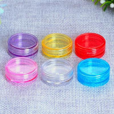 China 2g colorful plastic cosmetic lipbalm salve jars small jar for nail art glitter can make other colors of cap for sale