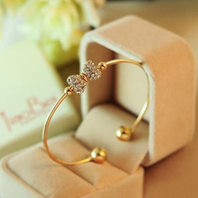 China FASHIONABLE Women's Thin Elegant Rhinestone Heart and Bowknot Bracelets Slap Bracelet Crystal Charming Accessory Rotatable Gold Color Jewelry for sale