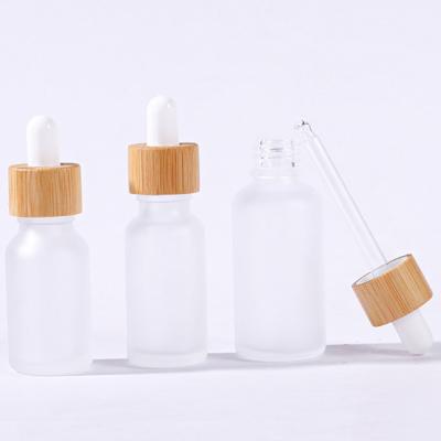 China Personal Care 5ml 10ml 15ml 20ml 30ml 50ml 100ml Frosted Glass Bottle Empty Essential Oil Bottle With Bamboo Wood Lid for sale