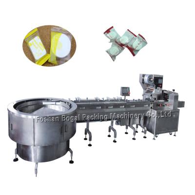 China Turntable Type Automatic Packaging Line Feedin For Compressed Facial Mask for sale