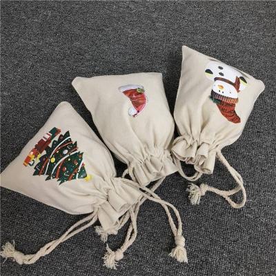 China 2021 New Gift Santa Sacks Christmas Drawstring Cotton Canvas Gift Candy Bags Santa Deer Elk Ride New Year Christmas Gifts for sale