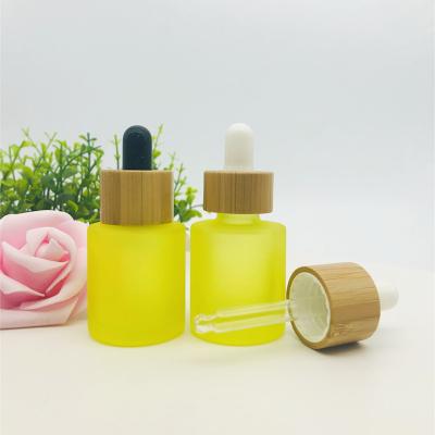 China 5ml cosmetic 10ml 15ml 20ml 30ml 50ml frosted yellow glass essential oil dropper bottle with bamboo lid for sale