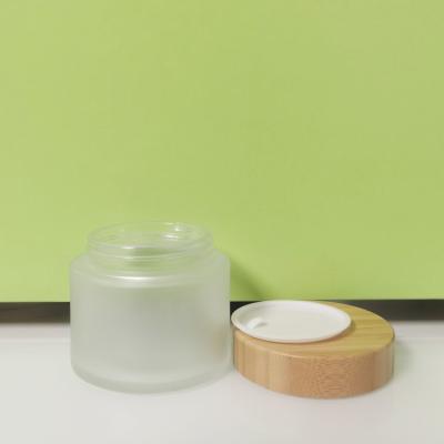 China 200ml Skin Care Cosmetic Cosmetics Packaging 200g Glass Jar Cream Empty Frosted With Bamboo Lid Wood Cap for sale